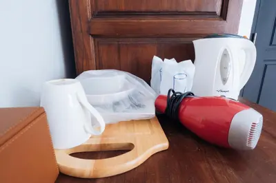 a red blender sitting on a counter next to a box at Pann Residence in Bangkok