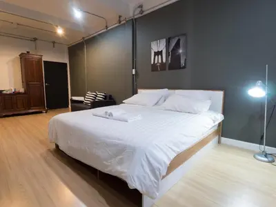 a bedroom with a large white bed in a room at Pann Residence in Bangkok