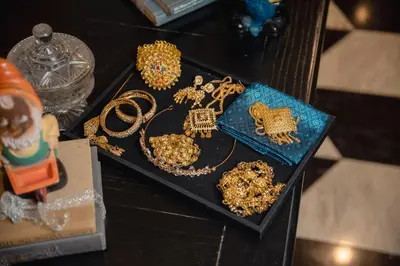 a black tray with gold jewelry on a table at The Salil Hotel Sukhumvit 57 - Thonglor in Bangkok
