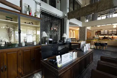 a restaurant with a reception desk in a lobby at IR-ON Hotel in Bangkok