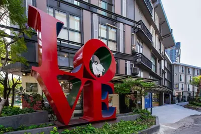 a large red sculpture in front of a building at BB House Khlong Tan บีบีเฮ้าส์ คลองตัน in Bangkok