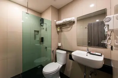a bathroom with a toilet and a sink and a shower at BB House Khlong Tan บีบีเฮ้าส์ คลองตัน in Bangkok