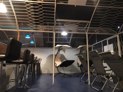 a room with a bunch of chairs and a table at Hoft Hostel Bangkok in Bangkok