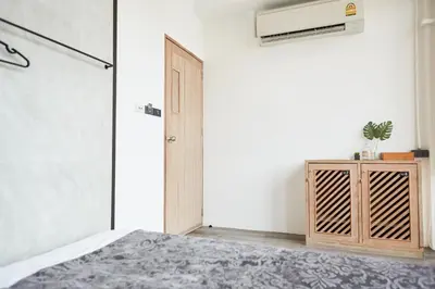 a bedroom with a bed and a closet and a heater at Vann Bangkok Boutique House in Bangkok