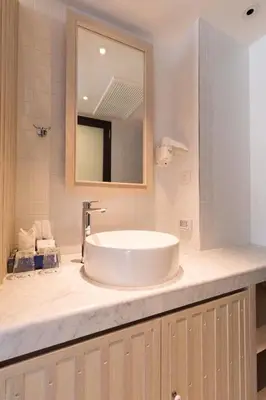 a bathroom with a sink and a mirror at Klub Hotel Bangkok in Bangkok