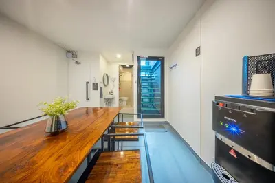 a kitchen with a wooden counter and a table at RALPH Bangkok in Bangkok