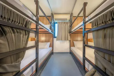 a room with two bunk beds in a bus at RALPH Bangkok in Bangkok