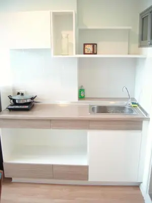 a kitchen with white cabinets and a sink at Bangkok view in Pinklao in Bangkok
