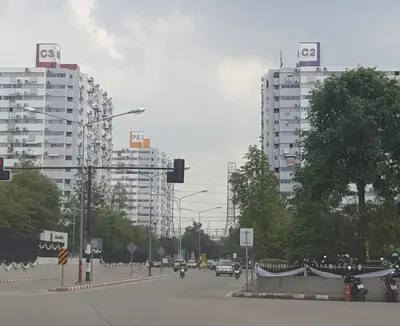 a city street with buildings and cars on the road at Popular Condo C6 in Nonthaburi
