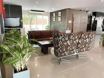 a living room with a couch and a table at 14 Place Sukhumvit Suites in Bangkok