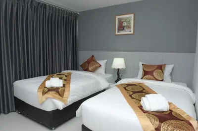 a hotel room with two beds with white sheets at Top High Airport Link Hotel, Bangkok in Bangkok