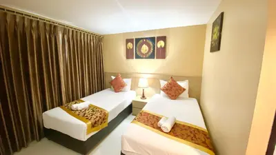 a hotel room with two beds and a window at Top High Airport Link Hotel, Bangkok in Bangkok