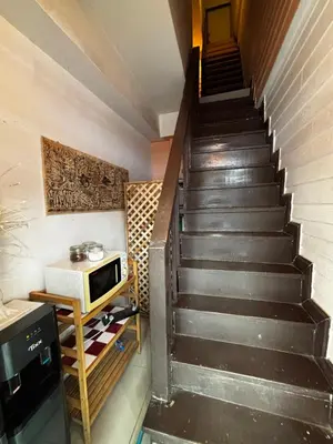 a staircase with a microwave and a television in a room at La Locanda in Bangkok