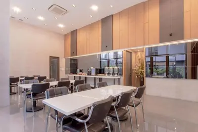 a meeting room with tables and chairs in a building at Kepler Residence Bangkok in Bangkok