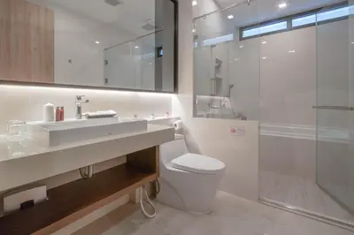 a bathroom with a toilet and a sink and a shower at Kepler Residence Bangkok in Bangkok