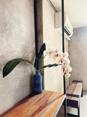 a vase of flowers sitting on a table at Yotaka The Hostel in Bangkok