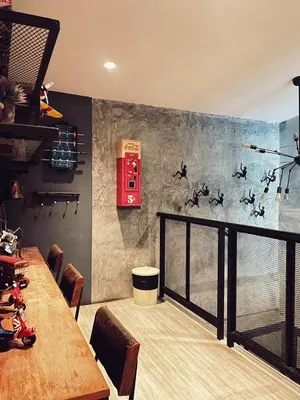 a dining room with a table and a red phone at Yotaka The Hostel in Bangkok