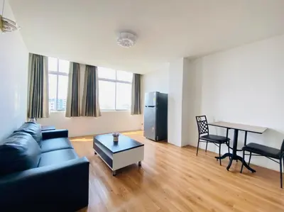 a living room with a couch and a table at City Residence in Bangkok