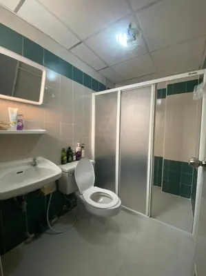 a bathroom with a shower and a toilet and a sink at City Residence in Bangkok