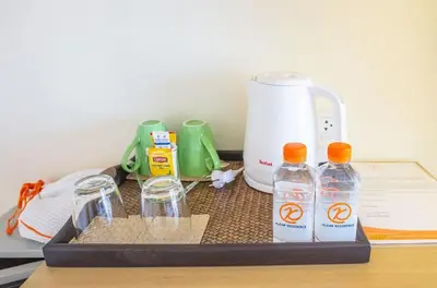 a tray with four bottles of water and a blender at Klean Residence Hotel in Bangkok