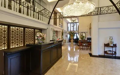 a large room with a lobby with a chandelier at Siam Champs Elyseesi Unique Hotel in Bangkok