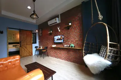a living room with a couch and a brick wall at Adagio Bangkok in Bangkok