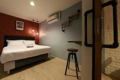 a bedroom with a bed and a stool in it at Adagio Bangkok in Bangkok