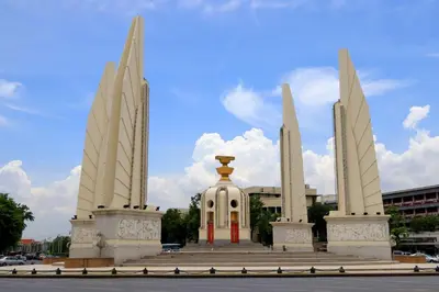 a monument with two towers and a red door at Krit Hostel in Bangkok