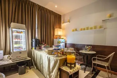 a room with a table and a refrigerator with food on it at Sudyod Apartment in Bangkok