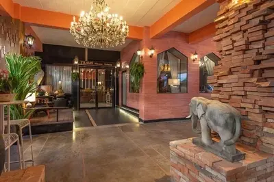 a lobby with an elephant statue in the center of a building at Sudyod Apartment in Bangkok