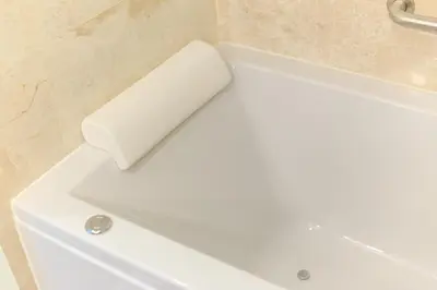 a white bath tub in a bathroom at The LA49 Hotel in Bangkok