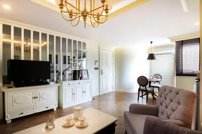 a living room with a couch and a tv at The LA49 Hotel in Bangkok