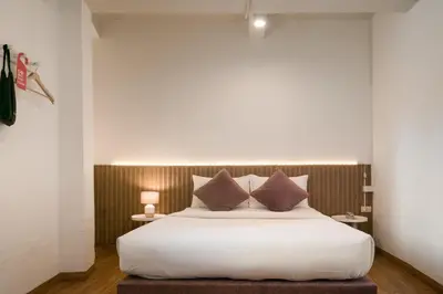 a bedroom with a large white bed with pillows at Hotel PaPa Bangkok Siriraj in Bangkok
