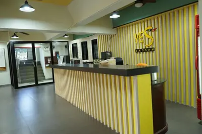 a restaurant with a yellow and white striped wall at Yes Kaosan in Bangkok