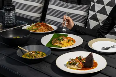 a table with plates of food on it at Theatre Residence in Bangkok