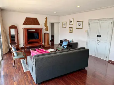 a living room with a couch and a table at Samsen Suites Spacious 2BR Contemporary Thai Style in Bangkok