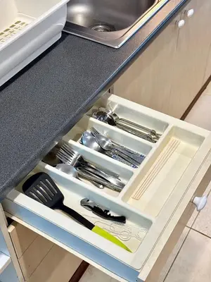 a drawer in a kitchen with some utensils at Samsen Suites Spacious 2BR Contemporary Thai Style in Bangkok