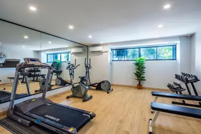 a gym with treadmills and exercise bikes in a room at Livotel Hotel Hua Mak Bangkok in Bangkok