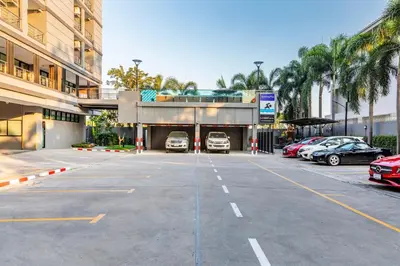 a parking lot with cars parked in a parking garage at Livotel Hotel Hua Mak Bangkok in Bangkok