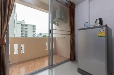 a room with a refrigerator and a window at Jr Mansion On Nut Soi 25 in Bangkok