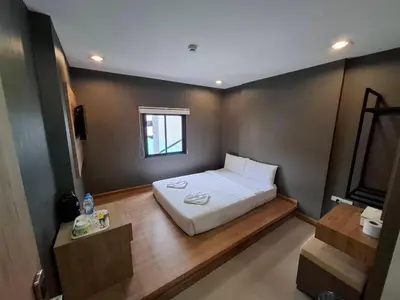 a small bedroom with a bed and a window at Collection O Pratunam 19 Hotel in Bangkok
