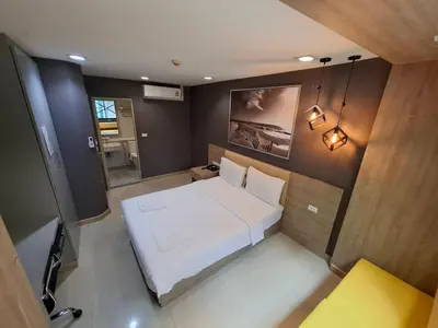 a small bedroom with a white bed in it at Collection O Pratunam 19 Hotel in Bangkok