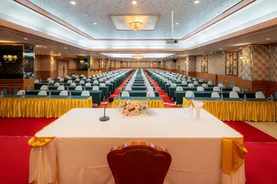 a large banquet hall with a table and chairs at Alexander Hotel in Bangkok