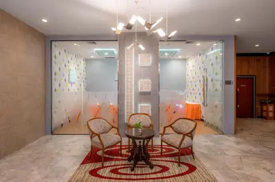 a meeting room with chairs and a table in front of a wall at Alexander Hotel in Bangkok