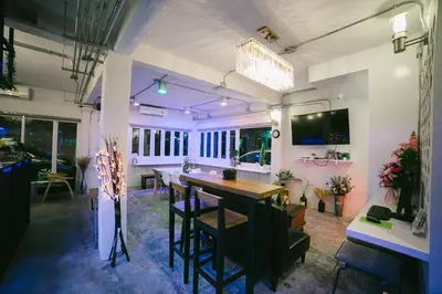 a dining room with a table and some chairs at Diff Hostel in Bangkok