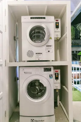 a washer and dryer in a small room at Diff Hostel in Bangkok
