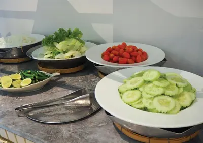 a bunch of plates of food on a counter at Kingston Suites Bangkok in Bangkok