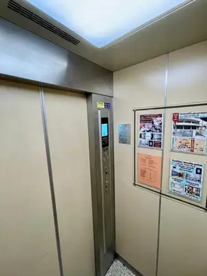 a elevator in a building with a sign on the wall at Sampheng Apartment in Bangkok