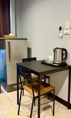 a black table with a tea kettle on top of it at Sampheng Apartment in Bangkok