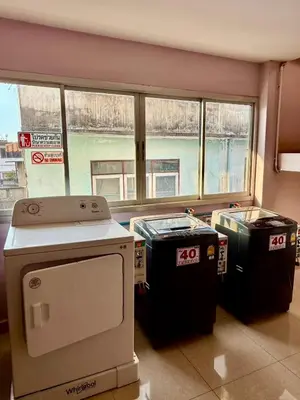 a room with three trash cans in front of a window at Sampheng Apartment in Bangkok